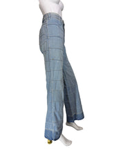 Load image into Gallery viewer, Light blue wide-leg denim jeans with a large grid patchwork pattern, displayed on a white mannequin.