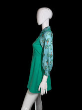 Load image into Gallery viewer, A green dress with a light blue patterned long-sleeve shirt-style overlay, displayed on a white mannequin.