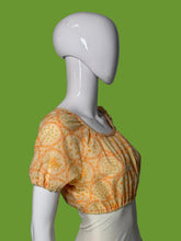 Load image into Gallery viewer, A short-sleeve blouse with an orange floral pattern, displayed on a white mannequin.