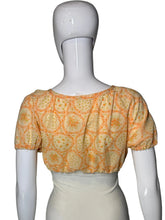 Load image into Gallery viewer, A short-sleeve blouse with an orange floral pattern, displayed on a white mannequin.