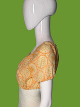 Load image into Gallery viewer, A short-sleeve blouse with an orange floral pattern, displayed on a white mannequin.