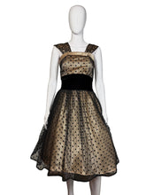 Load image into Gallery viewer, Black and cream polka dot dress on a mannequin with a plain background