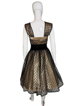 Load image into Gallery viewer, Black and cream polka dot dress on a mannequin with a plain background