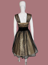 Load image into Gallery viewer, Black and cream polka dot dress on a mannequin with a plain background