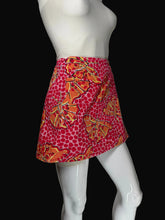 Load image into Gallery viewer, A women's skirt displayed on a white mannequin. The skirt features a vibrant red and pink base with a dense pattern of orange and yellow butterflies and dots.