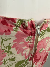 Load image into Gallery viewer, Floral-patterned fabric with a small home next to a zipper on a white background