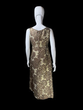 Load image into Gallery viewer, A sleeveless evening dress with a brown floral damask pattern on a gold background, displayed on a white mannequin
