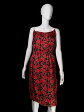 Load image into Gallery viewer, A sleeveless red and black floral midi dress displayed on a white mannequin against a plain indoor wall.