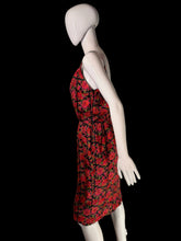 Load image into Gallery viewer, A white mannequin wearing a red and black floral print dress.