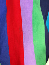 Load image into Gallery viewer, A close-up of a striped textile with vertical bands of blue, red, lavender purple, green, and dark navy.
