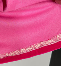 Load image into Gallery viewer, Close-up of pink fabric with lace trim and 'ALBERT NIPON FOK SWIRL' branding.