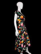 Load image into Gallery viewer, Mannequin wearing a colorful floral dress against a white wall.