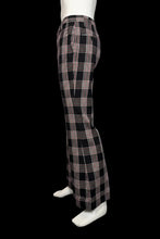 Load image into Gallery viewer, Black and white plaid pants on a mannequin against a plain background