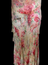 Load image into Gallery viewer, A sleeveless tiered maxi dress with a pink and red floral print on a beige base, displayed on a white mannequin.