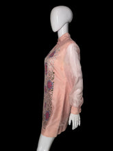 Load image into Gallery viewer, A pink embroidered tunic dress shown on a white mannequin. The dress features long sheer sleeves, a mandarin collar, and intricate floral and scroll embroidery in pink, purple, and gold.