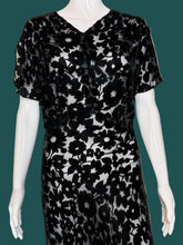 Load image into Gallery viewer, A black floral print silk burn out maxi dress displayed on a white mannequin.