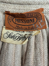 Load image into Gallery viewer, Close-up of a ribbed knit garment showing two brand labels: a brown Missoni tag and a cream-colored 'Saks Fifth Ave' tag sewn onto the neckline.