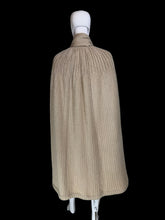 Load image into Gallery viewer, A beige ribbed knit cape with a draped collar and layered hem, displayed on a white mannequin.