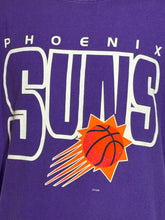 Load image into Gallery viewer, A close-up of a purple Phoenix Suns graphic t-shirt featuring the team name in bold white letters with an orange and red basketball logo.