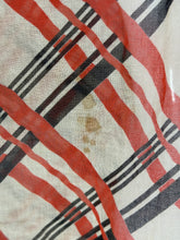 Load image into Gallery viewer, A close-up of a small stain on a plaid fabric pattern with diagonal red stripes, black and white stripes.