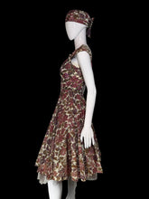 Load image into Gallery viewer, A sleeveless fit-and-flare dress with a matching headband, featuring a floral pattern in burgundy, olive green, and beige, displayed on a white mannequin.