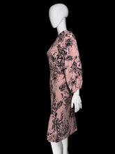 Load image into Gallery viewer, A pink long-sleeve dress with a black floral print displayed on a white mannequin.