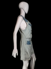Load image into Gallery viewer, A light blue denim overall romper displayed on a white mannequin, photographed against a plain off-white wall.