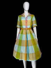 Load image into Gallery viewer, A short-sleeve midi dress with a colorful plaid pattern in yellow, green, light blue, and orange, displayed on a white mannequin.