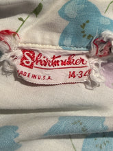 Load image into Gallery viewer, Close-up of a vintage shirt label reading 'Shirtmaker' in red embroidery on a white fabric background with a blue and green floral print.