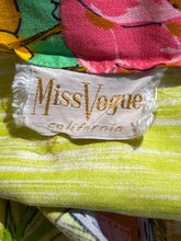 Load image into Gallery viewer, Close-up of a colorful fabric item with a visible MissVogue California brand label. The textile features a bright lime green and white striped lower section, a pink floral section, and a green/yellow patterned section.
