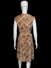 Load image into Gallery viewer, A sleeveless fit-and-flare dress with a geometric diamond pattern in orange, brown, and beige, displayed on a white mannequin.