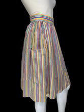 Load image into Gallery viewer, A vintage striped skirt shown on a white mannequin. The skirt features vertical stripes in yellow, blue, orange, and red on a white base, with side pockets.