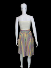 Load image into Gallery viewer, A vintage striped skirt shown on a white mannequin. The skirt features vertical stripes in yellow, blue, orange, and red on a white base, with side pockets.