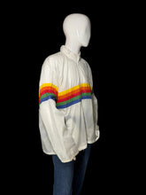 Load image into Gallery viewer, A side view of a white windbreaker jacket with a bold rainbow stripe across the chest and upper back, shown on a white mannequin.