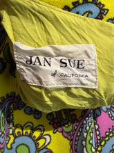 Load image into Gallery viewer, Close-up of a garment label reading JAN SUE of CALIFORNIA on a bright yellow fabric, with a colorful paisley pattern visible around it.