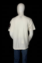 Load image into Gallery viewer, An off-white short-sleeve t-shirt displayed on a white mannequin from the back.
