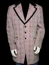 Load image into Gallery viewer, A men's blazer jacket displayed on a white mannequin torso, featuring a dusty pink and red abstract pattern with black contrast piping on the lapels and front opening.