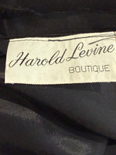 Load image into Gallery viewer, Close-up of a black garment label reading 'Harold Levine BOUTIQUE' on dark fabric.