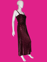 Load image into Gallery viewer, A sleeveless, floor-length burgundy sequined gown displayed on a white mannequin.