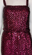 Load image into Gallery viewer, A sleeveless sequined dress displayed on a white mannequin. The dress features a square neckline, wide shoulder straps, and a full skirt covered in shimmering magenta-pink sequins.