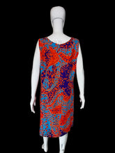 Load image into Gallery viewer, A sleeveless A-line dress with a vibrant red, orange, and blue paisley pattern, displayed on a white mannequin.