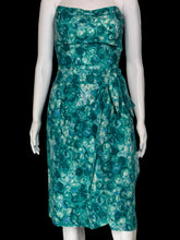Load image into Gallery viewer, A strapless knee-length dress with a green and teal floral pattern, displayed on a white mannequin.
