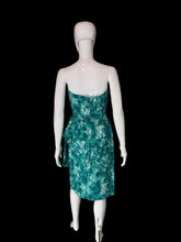 Load image into Gallery viewer, A strapless knee-length dress with a green and teal floral pattern, displayed on a white mannequin.