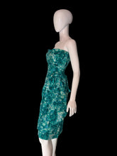 Load image into Gallery viewer, A strapless knee-length dress with a green and teal floral pattern, displayed on a white mannequin.