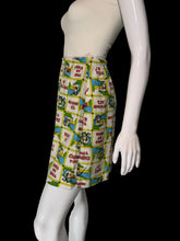 Load image into Gallery viewer, A high-waisted, pleated mini skirt featuring a colorful patchwork print of vintage comic book panels with text like 'PLEASE BE SEATED' and 'THAT'S ALL FOLKS!'.