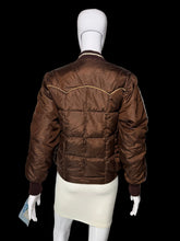 Load image into Gallery viewer, A brown quilted bomber jacket with gold contrast stitching, displayed on a white mannequin from the back.