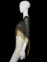 Load image into Gallery viewer, A black mesh and tulle wrap with gold fringe and gold embroidered detailing, displayed on a white mannequin torso.