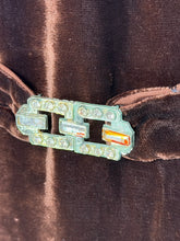 Load image into Gallery viewer, An extreme close up of a dark brown velvet 1920s midi length dress with a matching belt featuring a bedazzled buckle.