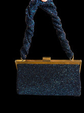 Load image into Gallery viewer, A small rectangular evening bag covered in dark blue rhinestones, with a gold-tone frame and a thick, twisted blue beaded handle.