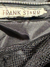 Load image into Gallery viewer, Close-up of a black garment interior showing a zipper, a sewn-in label reading FRANK STARR, and black mesh fabric.